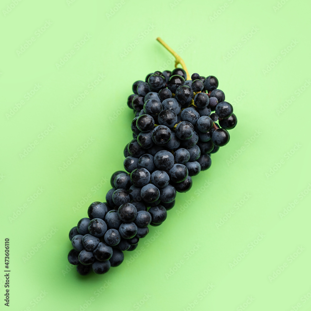Cluster of grapes on a flat green background Cluster of grapes on a flat green background