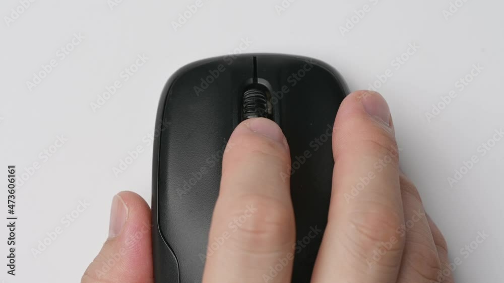 Clicking digital wireless mouse and working on computer at the office. Close up hand on mouse. The concept of using technology. Computer for business. Clicking digital wireless mouse and working on computer at the office. Close up hand on mouse. The concept of using technology. Computer for business.