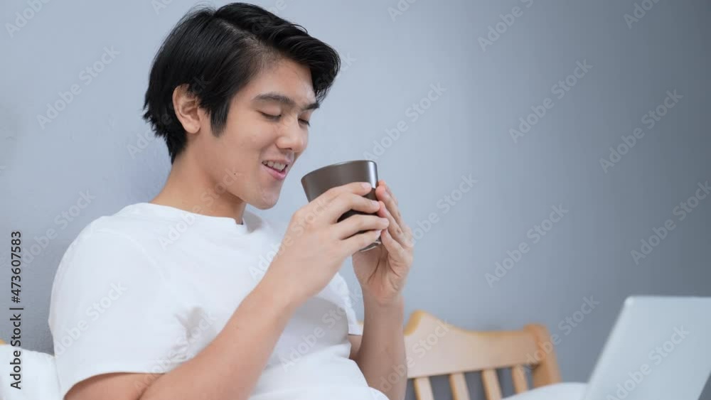 Holiday concept of 4k Resolution. Asian man drinking coffee happily in bedroom. break time from work. fresh scent. Holiday concept of 4k Resolution. Asian man drinking coffee happily in bedroom. break time from work. fresh scent.