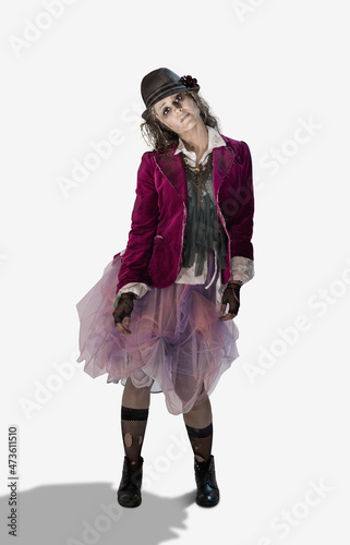Woman dressed up as a zombie wearing a fedora and ripped stocking looking into camera with dead expression for Halloween, on white background photo