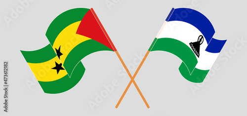 Crossed and waving flags of Sao Tome and Principe and Kingdom of Lesotho
