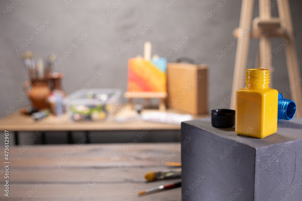 Paint brush and artist tools with cube on wood table. Paintbrush art painter supplies on desk Paint brush and artist tools with cube on wood table. Paintbrush art painter supplies on desk