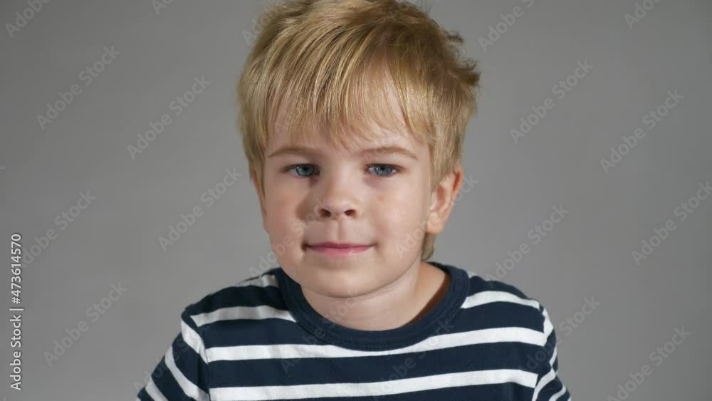 Happy Child Face Emotions Facial Expressions. Portrait Cute Little Boy. Glad Smiling Joyful Kid against White Wall Background. 2x Slow motion 60fps 4K Happy Child Face Emotions Facial Expressions. Portrait Cute Little Boy. Glad Smiling Joyful Kid against White Wall Background. 2x Slow motion 60fps 4K