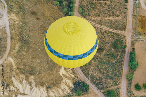Yellow Hot air balloons flying over Cappadocia landscape, aerial view, Goreme National Park ,Turkey