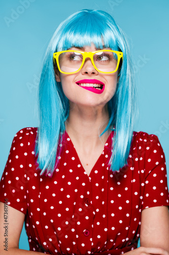 glamorous woman in blue wig yellow glasses posing model