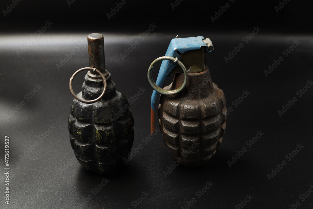 Fototapeta premium Russian and american grenades on black background