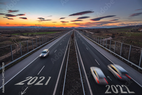 Driving on open road at beautiful sunny day to new year 2022. Aerial view