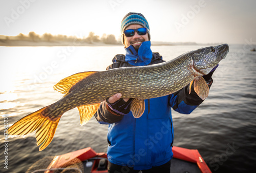 Fisherman and trophy Pike. Fishing background. 