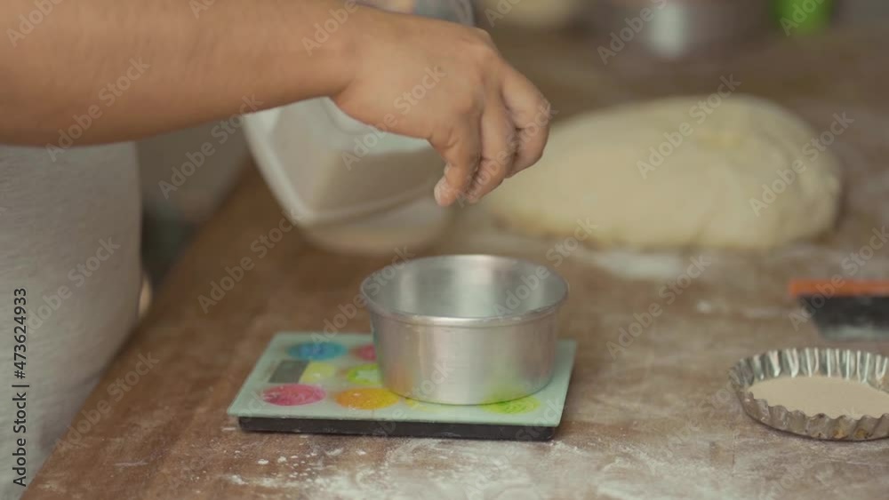 Latin man's hands weighing flour Latin man's hands weighing flour