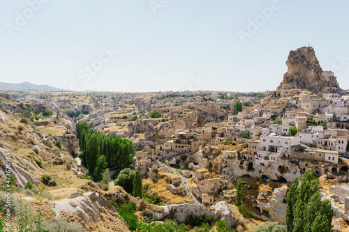 Cappadocia, Turkey - 20 July 2021. Day view of Goreme town with blue clear sky on horison. Famous center of balloon fligths