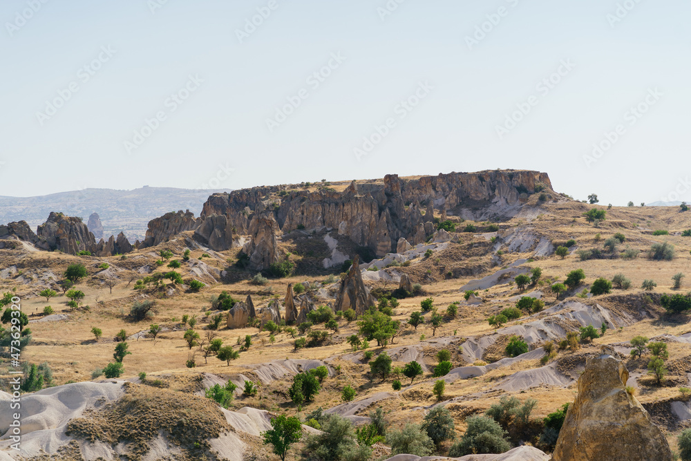 Picturesque summer view Scenic on landscape view of geologic formations of Cappadocia. Amazing shaped sandstone rocks. Famous touristic place and romantic travel destination..