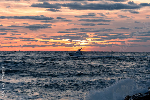 Fishing boat at sunrise of the New Jersey Coastline photo