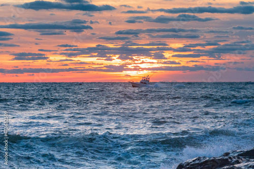 Fishing boat at sunrise of the New Jersey Coastline photo