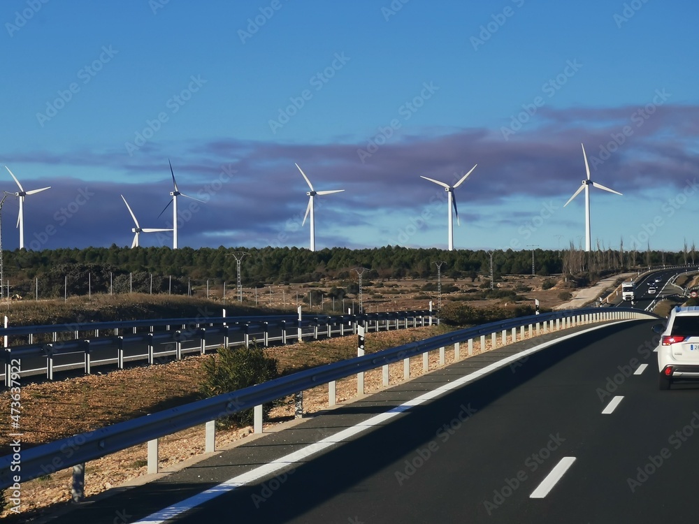 group of modern windmills for clean energy generation