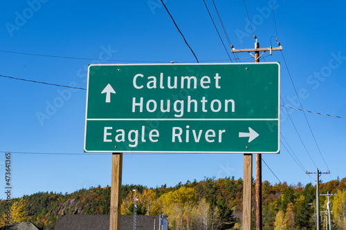 Road sign giving directions to cities in the Upper Peninsula of Michigan - Eagle River, Calumet, and Houghton
