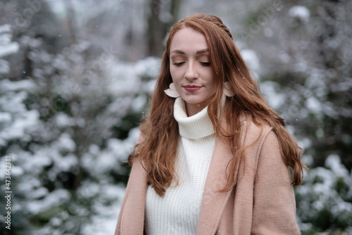 A woman in her twenties standing in the snow photo