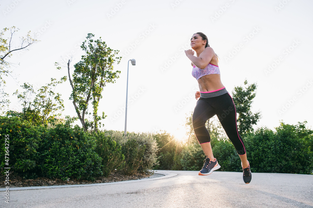 Woman running in backlit Woman running in backlit