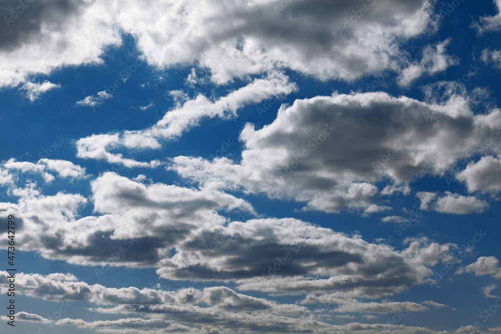 Flying clouds in the daytime . Blue atmosphere with clouds Flying clouds in the daytime . Blue atmosphere with clouds