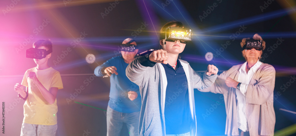 Teenage girl using virtual reality glasses with her family