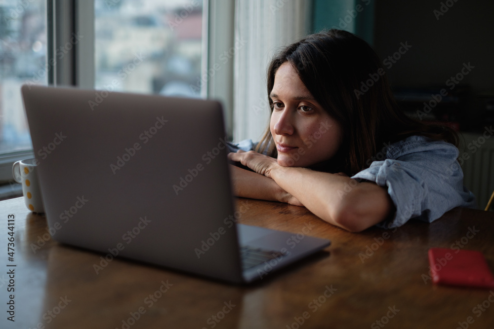 Woman watch something on laptop at home in the evening Woman watch something on laptop at home in the evening