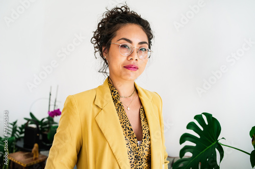 Woman in a yellow blazer looking at camera photo