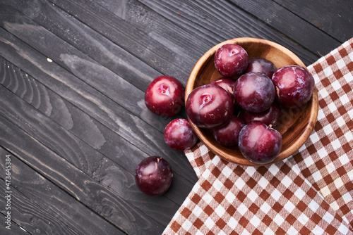 plums fruits natural products on a wooden table top view