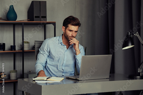 Thoughtful man in a home office photo