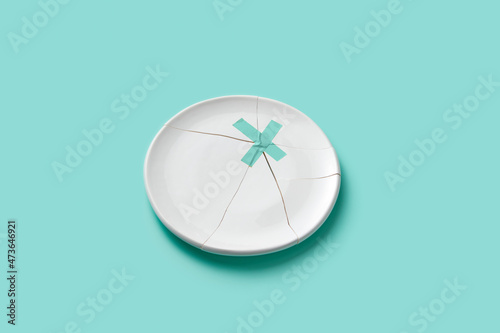 Broken plate fixed with turquoise tape