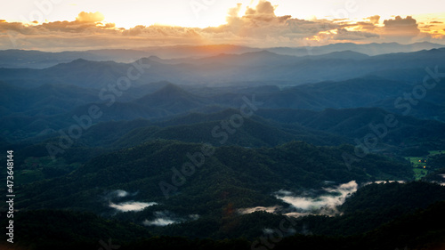 Misty forest in Mountain Landscape at twilight sunset