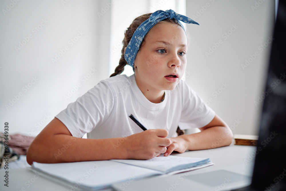 Female pupil doing task at home Female pupil doing task at home