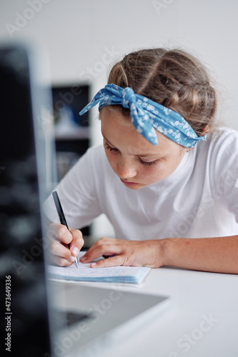 Girl try to comply her own homework independently