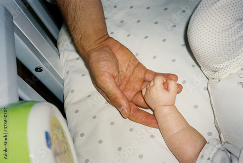 Small hand holding an adult