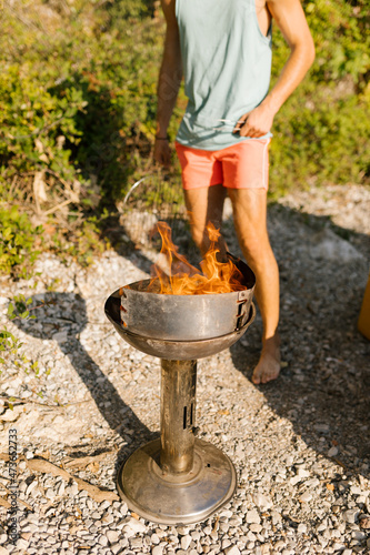 Friends preparing barbecue at the beach photo