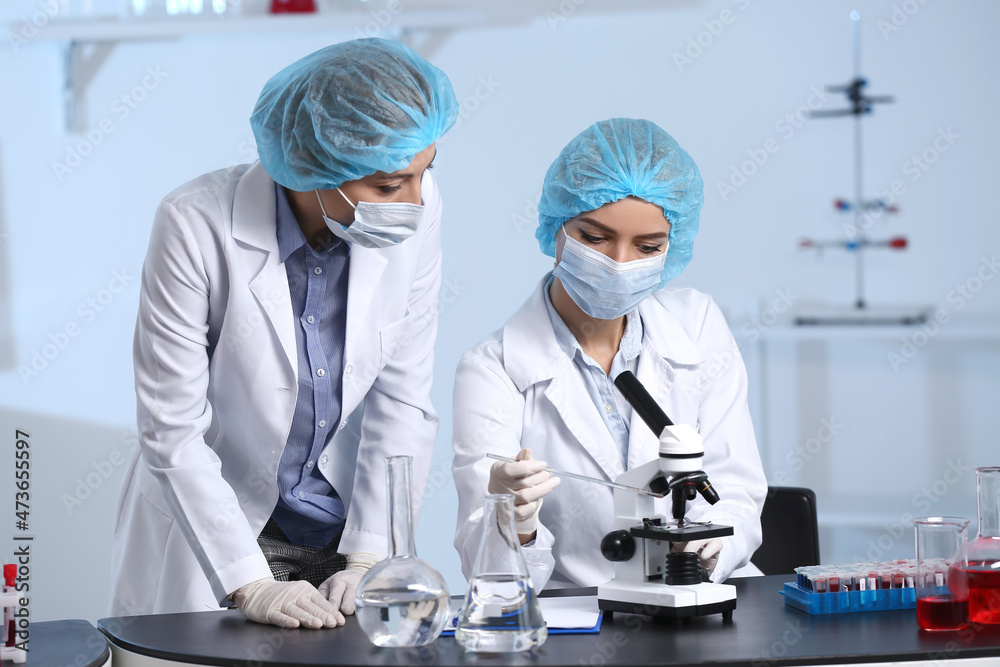 Scientists studying sample in laboratory