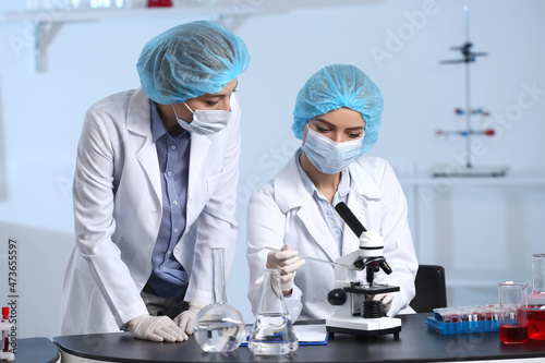 Scientists studying sample ...