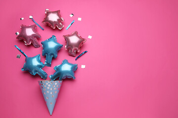 Beautiful balloons and party hat on pink background