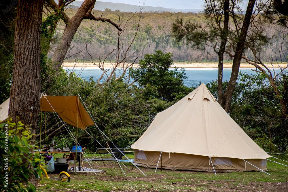Φωτογραφία Family tent setup at the campsite surrounding by bush forest near the ocean bay in Australia