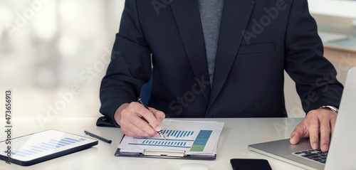 Fototapeta Naklejka Na Ścianę i Meble -  businessman working at office with document on his desk, doing planning analyzing the financial report, business plan investment, finance analysis concept.