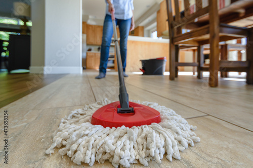 Woman mopping her kitchen floor photo