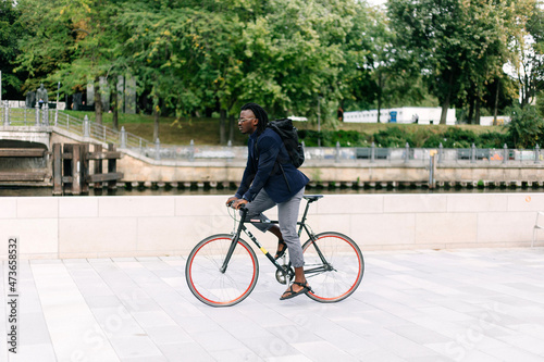 A beautiful black man riding his bike photo
