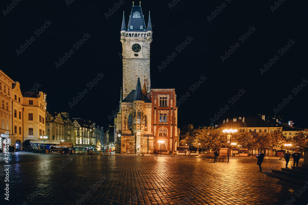view of a dark and illuminated cobblestone street in the old town of prague at night 2021