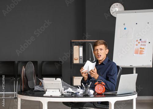 Displeased young businessma...