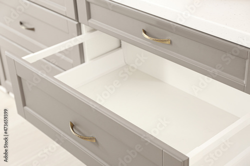 Opened kitchen drawer in room, closeup