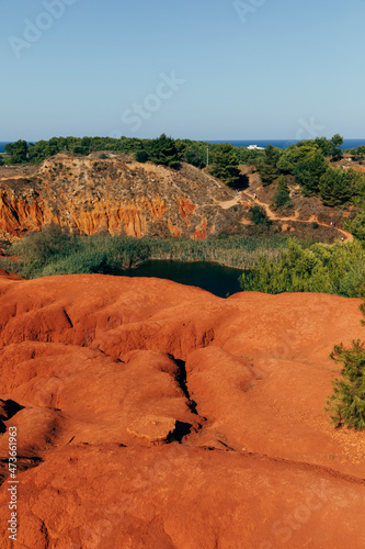 Landscape of disused bauxite quarry with little lake photo