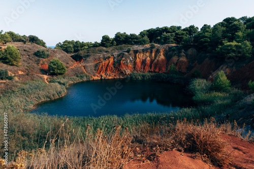 Disused bauxite quarry with little lake