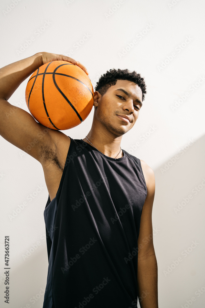 Confident black basketball player in studio