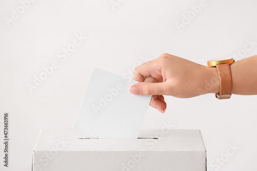 Voting woman near ballot box