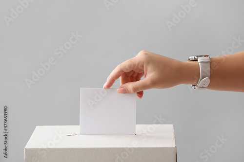 Voting woman near ballot box