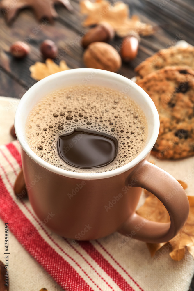 Cup of coffee with acorns on table, closeup Cup of coffee with acorns on table, closeup