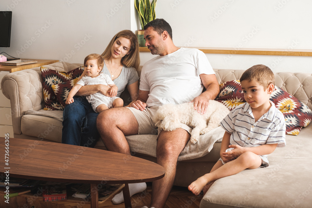 Family Of Four Watching TV In The Living Room Family Of Four Watching TV In The Living Room